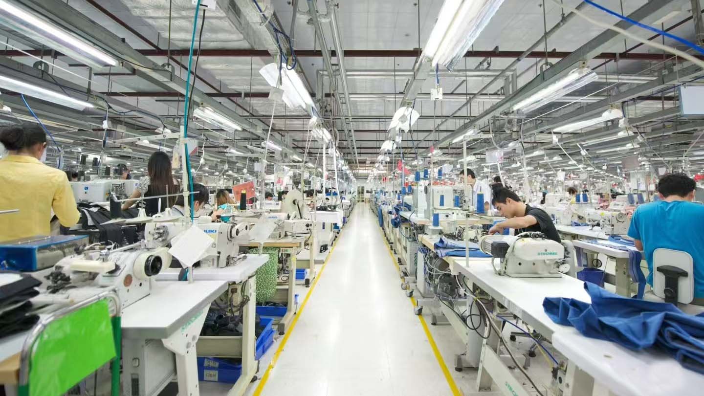 inside a golf apparel factory showing specialized sewing machines