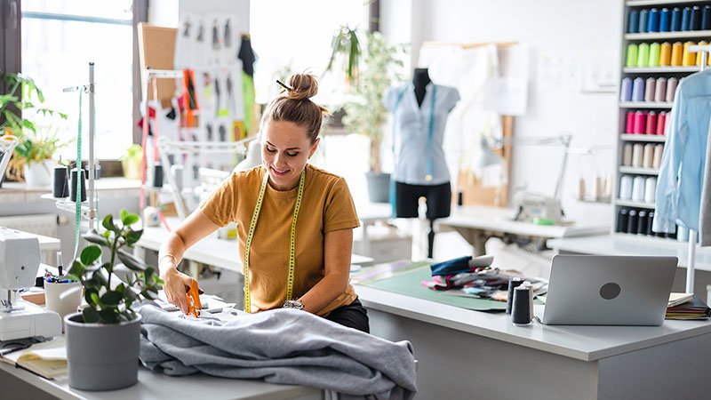 a designer measuring a custom golf polo