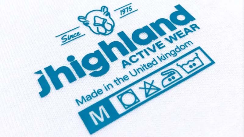 A heat press applying a transfer logo to a golf polo