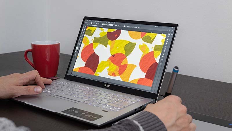 a designer working on a complex pattern on a computer for a golf polo