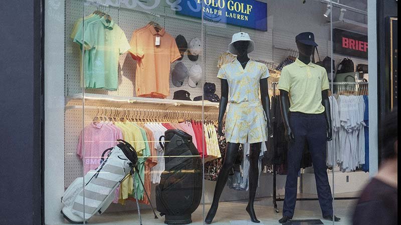 a professional golfer winning a tournament wearing a major brand's apparel
