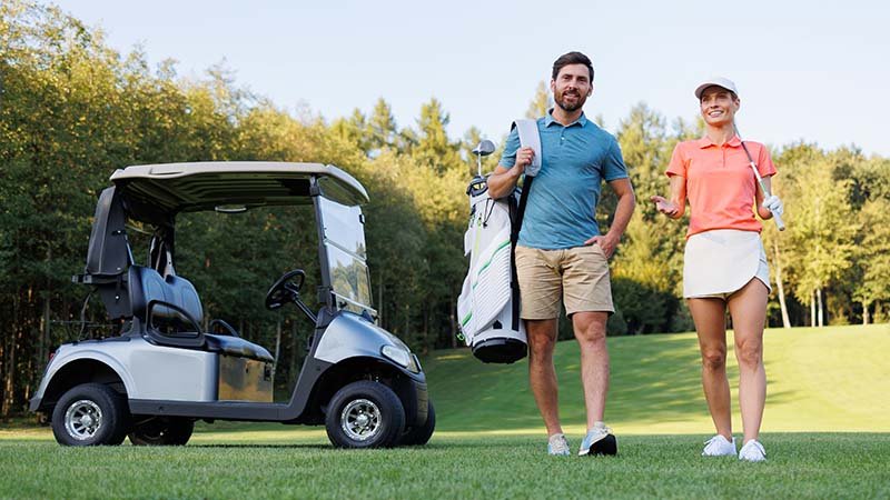 A golfer in mid-swing wearing a performance polo