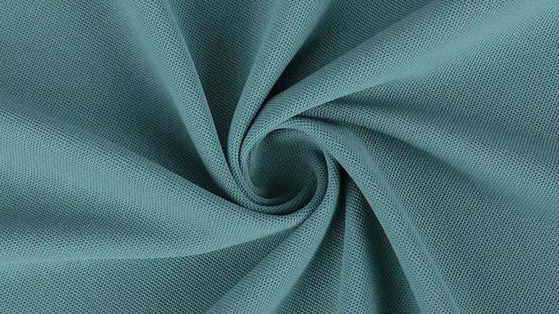 A close-up shot of different performance fabric swatches for golf polos.