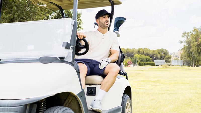 an adult in elegant clothes has fun one day on a golf course.the