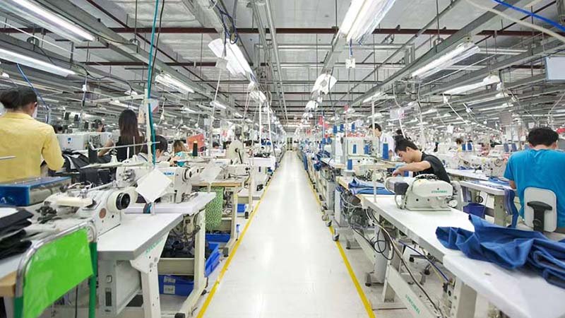 Apparel buyer discussing quality control with a factory manager