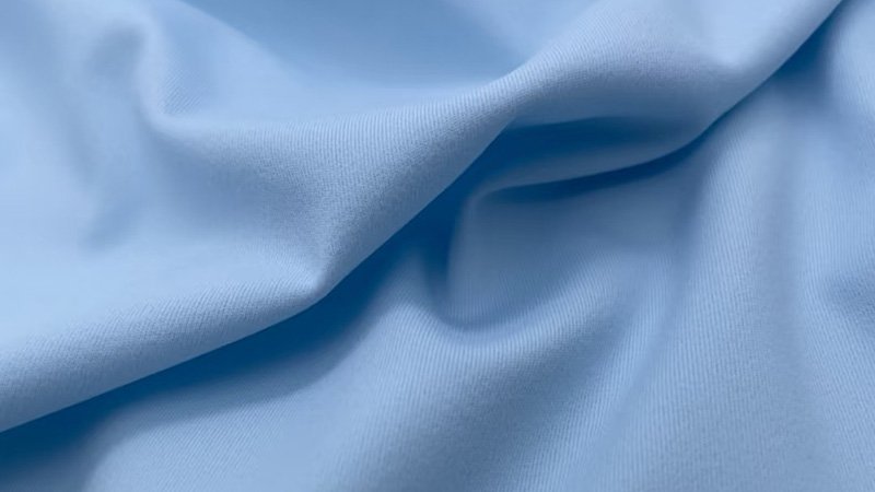 A close-up of moisture-wicking golf polo fabric